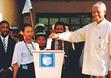 Click the image for a view of: Mandela casting his vote in 1994